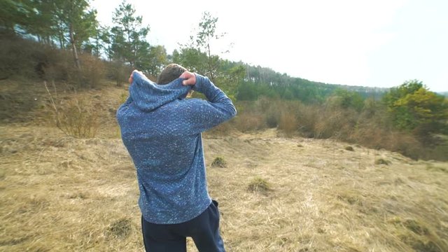 Back look of the young man walking back and shows fuck . Slowly