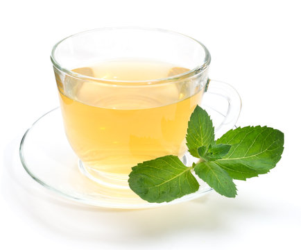 Green tea in transparent cup with mint leaves isolated on white