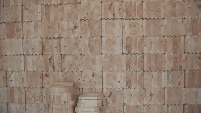 Close-up of a wall, upholstered wooden elements. Interior room with wood elements. Glued laminated timber in the interior. Glued laminated timber in the form of squares with carvings for joints.