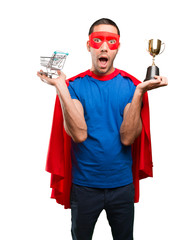 Surprised superhero with a shopping cart