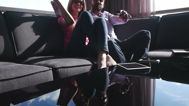 couple at home relaxing on couch and enjoying free time