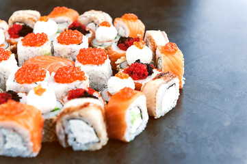Sushi net on a black surface. Flat lay