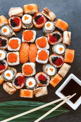 Sushi net on a black surface. Flat lay