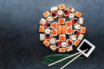 Sushi net on a black surface. Flat lay