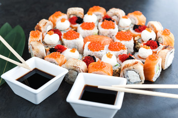 Sushi net on a black surface. Flat lay