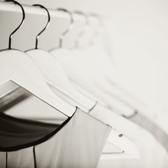 Black-and-white photo with the blur. Women's clothing on a white hanger.