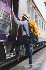 Traveler girl with backpack walk up the train alone. travel journey by train