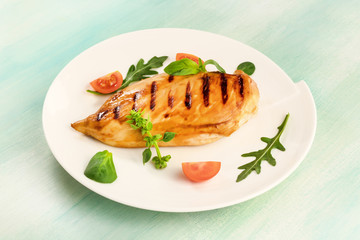 Grilled chicken fillet with cherry tomatoes and salad leaves