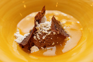 Ice cream dessert in yellow plate, close-up