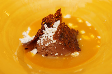 Ice cream dessert in yellow plate, close-up