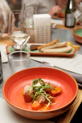 Game bird fillet with sweet potato mash in red clay plate