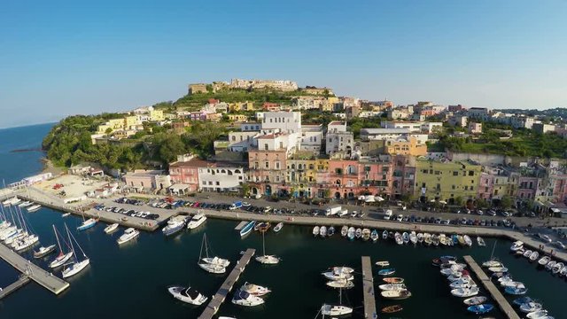 Mediterranean seaside town aerial shot, boats docked in port, summer vacation