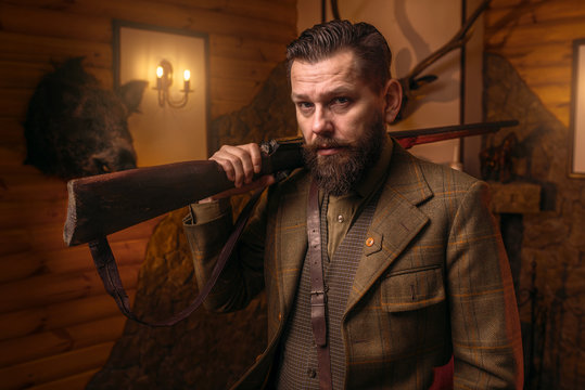 Hunter man in vintage clothing with antique rifle