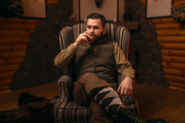 Fototapeta premium Hunter man drink alcohol after successful hunt