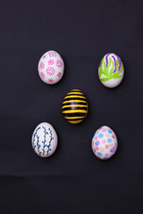 Easter eggs painted on black.