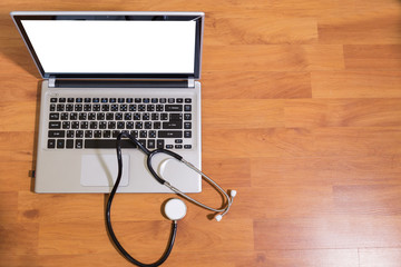 Medical stethoscope and laptop computer on doctor 's desk