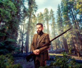 Hunter in vintage hunting clothing with old gun