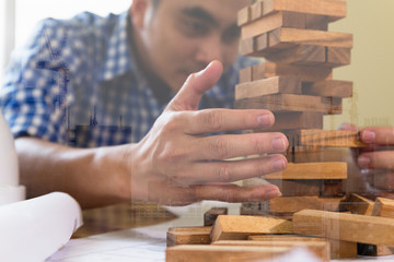 Planning, risk and strategy of project management in architect and engineer man gambling placing woon block on a tower, double exposure with crane and building under construction