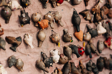 Handmade toy clay whistles in the forms of animals and cat