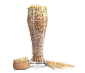 Glass full of barley seeds isolated on white