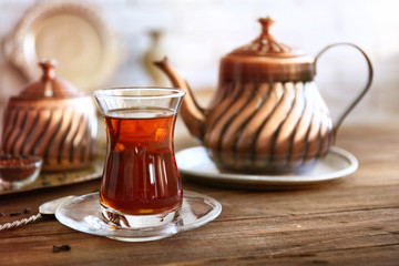 Turkish tea in traditional glass on wooden table closeup