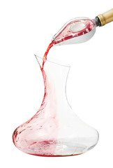 Pouring red wine into decanter on white background