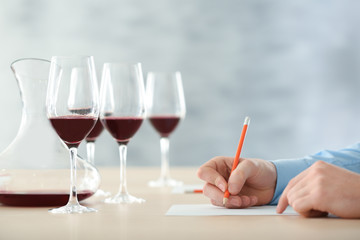 Sommelier estimating red wine in wineglass at tasting