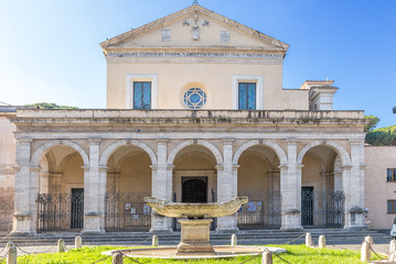 Obraz premium Rome, Italy. The central facade of the church of Santa Maria alla Navicella (VII - XVI centuries) and the fountain in the form of a ship