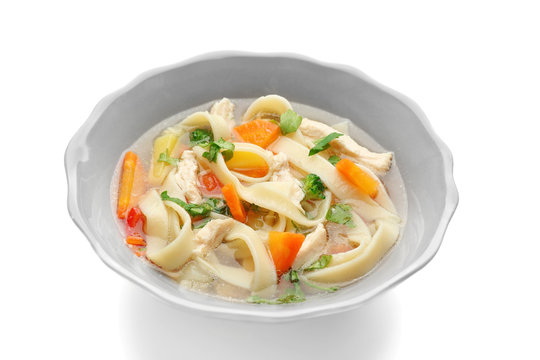 Chicken noodle soup in plate on white background