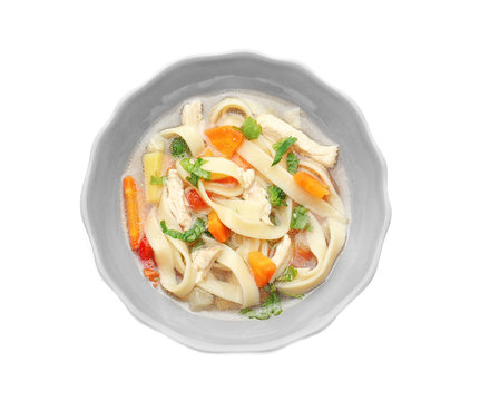 Chicken noodle soup in plate on white background