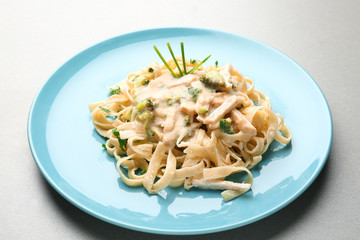 Plate with delicious chicken Alfredo on table