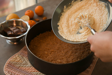 Woman making tasty cheesecake, closeup