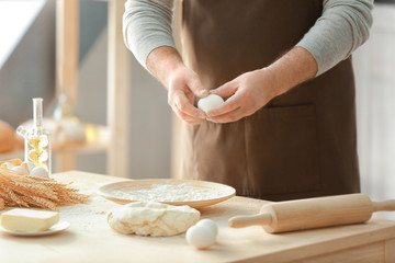Fototapeta na wymiar Man making dough in kitchen
