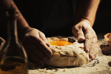 Man making dough in kitchen, closeup