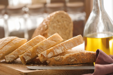 Cut bread and knife on kitchen board