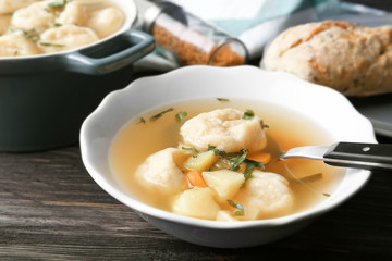 Portion of delicious chicken and dumplings on dining table