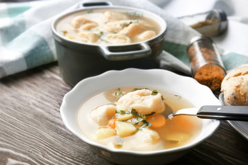 Portion of delicious chicken and dumplings on dining table