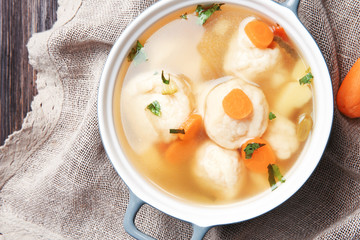 Ceramic pan with delicious chicken and dumplings on decorative napkin