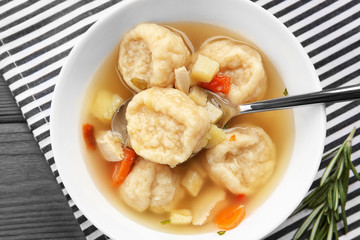 Portion of delicious chicken and dumplings on dining table
