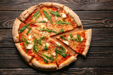 Delicious pizza on wooden table, top view