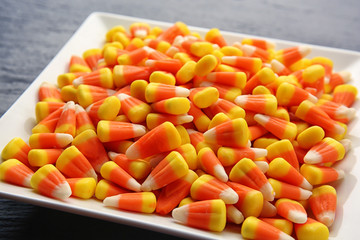 Plate with tasty Halloween candies, closeup