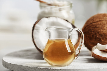 Fresh coconut oil in glassware on wooden tray