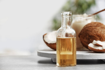 Fresh coconut oil in glassware on grey table