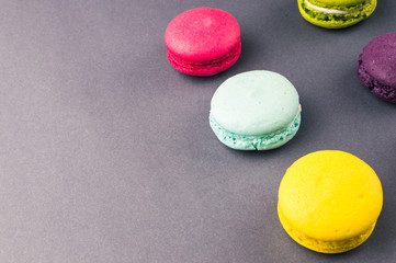 Colourful french macaroons on the grey background