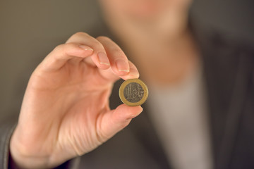 Fototapeta na wymiar Businesswoman and one euro coin