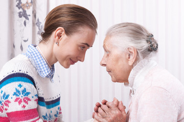 Care is at home of elderly. Space for text. Senior woman with their caregiver at home. Concept of health care for elderly old people, disabled. Elderly woman.