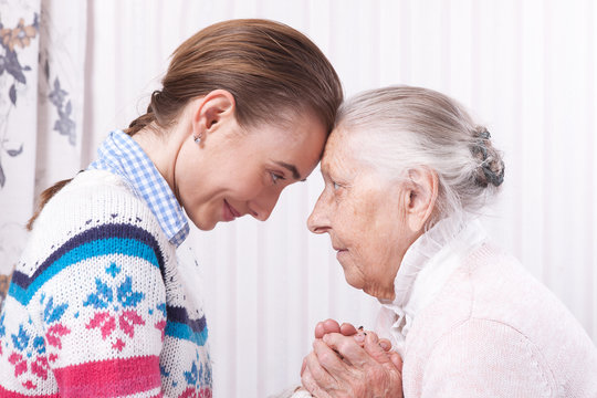 Helping hands, care for the elderly concept Senior and caregiver holding hands at home