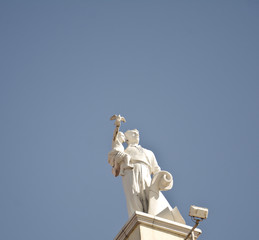 An architectural ensemble in belarus, minsk, an adult man holds a child on his hand who has a dove...