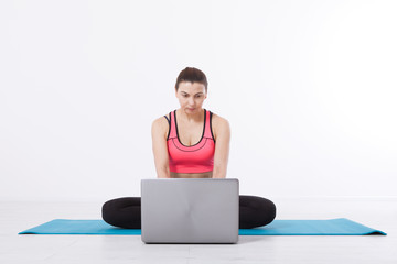 Sport. Fitness Yoga woman. A middle-aged woman conducts yoga training using a laptop and Internet communication