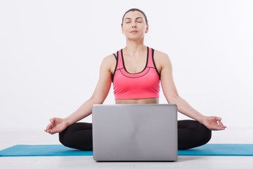 Sport. Fitness Yoga woman. A middle-aged woman conducts yoga training using a laptop and Internet communication